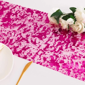 Detailed macro view of rose red foil mesh table runner with metallic lace texture