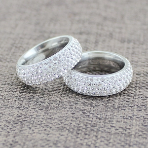 Elegant titanium steel rings with five rows of sparkling diamonds on textured fabric