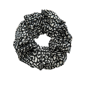 Retro black and white leopard print fabric scrunchie with minimalist aesthetic
