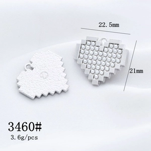Detail of silver pixel heart charm with pearl inlay measuring 22.5mm by 21mm