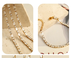 Detail of gold tennis chain with alternating rectangular and round cubic zirconia stones