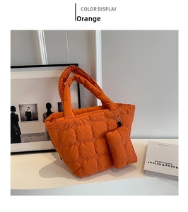 Detail of orange quilted puffer tote bag with matching mini coin purse on metallic chain