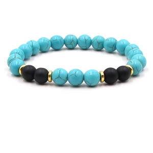 Detail of turquoise beaded bracelet with matte black beads and gold metallic spacers