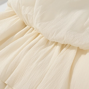Detailed macro view of cream pleated fabric with soft vertical texture for sexy dresses