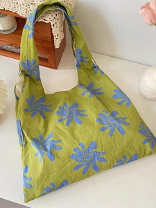 Floral canvas tote bag with blue sunflowers on green background for daily commuting