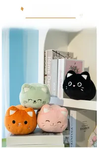 Detailed view of four colorful plush cat keychains on a shelf with embroidery details