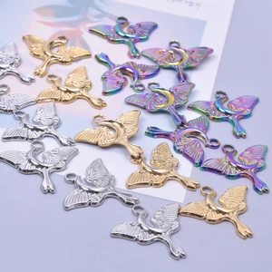Detailed view of gold, silver and rainbow moth charms with moon elements for DIY jewelry