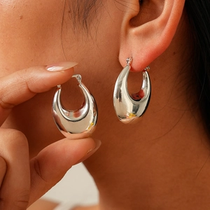 Polished silver metal oval hoop earrings with minimalist U-shaped design for women