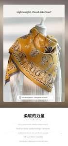 Close-up of yellow cashmere-like scarf featuring intricate paisley patterns and fringe