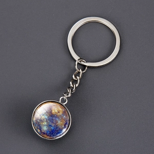 Detailed macro view of silver solar system keychain with Mercury planet glass pendant