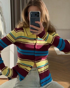 Close-up of retro ribbed knit cardigan featuring yellow, burgundy and blue stripes