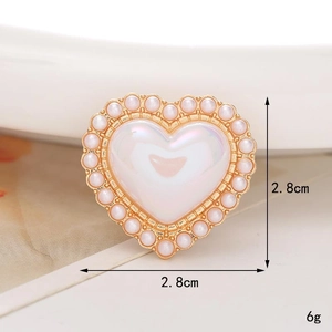 Close-up of heart-shaped shoe charm with faux pearls and iridescent white inlay, 2.8cm size