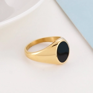 Detailed side view of a gold-plated stainless steel ring with a black oval inlay piece