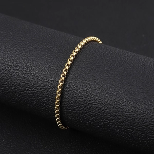 Close-up of polished 18K gold-plated stainless steel box chain with detailed links