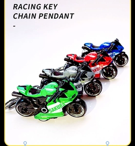 Macro display of four colorful alloy racing car keychains in green, red, blue, and gray
