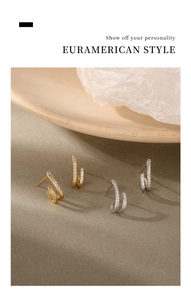 Detailed close-up of double-row U-shaped 925 silver hoop earrings with zircon inlays