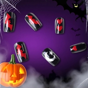 Halloween press-on nails featuring red bats and moon stars on long black rectangular tips