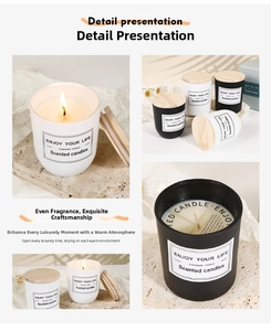 Close-up of matte glass scented candles with natural wooden lids on a stone base