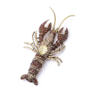 Vintage lobster brooch with red crystal pavé and yellow teardrop stone on bronze base