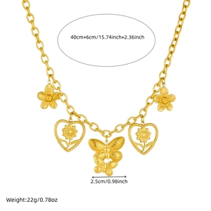 Gold plated stainless steel butterfly and flower pendant necklace on white background