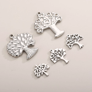 Detailed view of five unique silver stainless steel tree of life charms for jewelry DIY