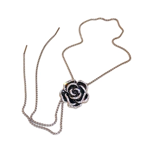 Vintage camellia necklace with black enamel petals and shimmering zircon in gold finish
