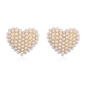 Detailed close-up of heart-shaped pearl earrings with elegant gold metal plating