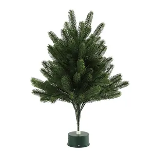 Miniature green artificial Christmas tree with dense needles and stable round base