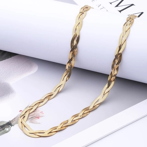 Detailed view of triple-braided gold blade snake chain necklace with woven texture