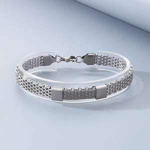 Detail of woven stainless steel snake chain bracelet on a transparent circular stand