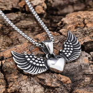 Gothic wings heart pendant in stainless steel with textured feathers on a box chain