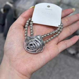 Élastique à cheveux rose en similicuir argenté avec chaînes à billes métalliques