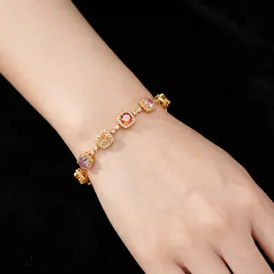 Vintage gold bracelet with multi-color gemstones and zircon halo on velvet sleeve
