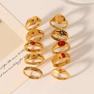 Collection of gold-plated stainless steel rings with red zircon and celestial patterns