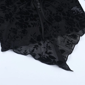 Détail du tissu en maille transparente noire avec flocage floral élégant et texture 3D
