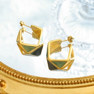 Chic geometric enamel gold earrings with green drip oil finish on a mirror tray