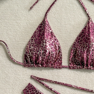 Detail of metallic leopard print bikini with pink and silver spots and drawstring ties