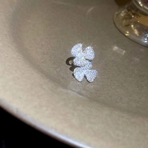 Macro detail of double floral zircon ear cuff in silver finish with sparkling stones
