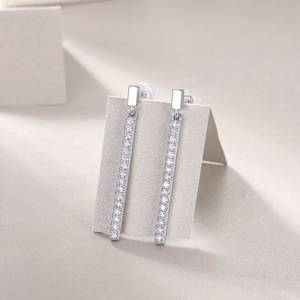 Macro shot of 925 sterling silver long drop earrings featuring inlaid moissanite detail