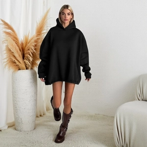 Detailed view of women's black oversized drawstring hoodie with cozy knitted texture