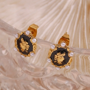 Detail of 18K gold-plated U-shaped earrings with black enamel and white pearls