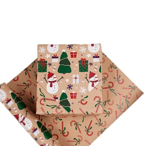 Christmas kraft wrapping paper rolls with festive snowman and tree patterns for gifts