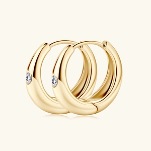Minimalist gold hoop earrings featuring delicate white moissanite stones on cream background