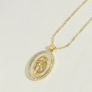 Close-up of gold MOM pendant with zircon inlay and mother-child emblem for Mother's Day