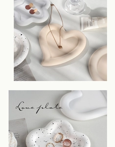 Macro detail of heart-shaped ceramic jewelry tray with matte finish and ink splatter design
