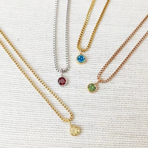 Detailed view of colorful 8mm birthstone round pendants on gold and silver box chains