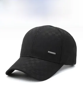 Detail of black baseball cap with checkerboard weave and side metal plaque accent