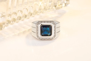 Close-up of square blue sapphire ring with micro-pave cubic zirconia on silver band