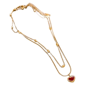 Double-layered gold necklace with red heart enamel pendant and bead accents