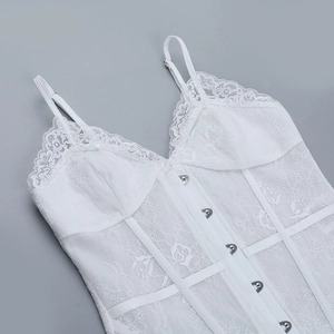 Detail shot of white lace bodysuit featuring adjustable straps and hook-and-eye closure